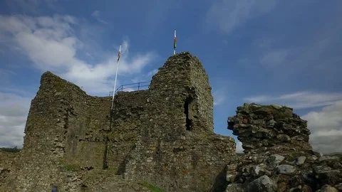 Panning view of a Welsh castle with welsh flags. Stock Footage 80094696