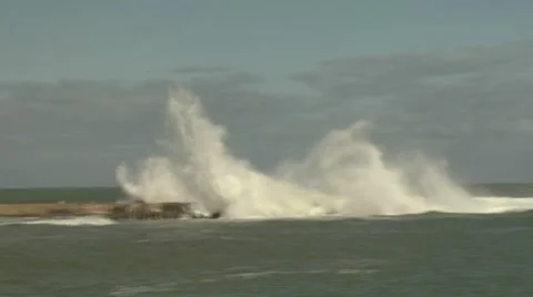Panning with a wave as it washes down a seawall Stock Footage 8509739