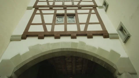 Panning up while gliding through an old town in a Swiss village in Switzerland Stock Footage 329652852