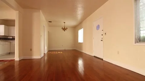 Panning Wide angle shot of empty house with white walls and wood floors Video stock 45524055