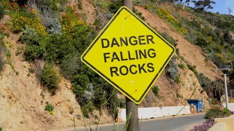 Panning of yellow danger falling rocks sign Stock Footage 106480433