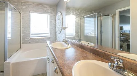Pano Master bathroom with a warm lightning and stone tile walls Stock Photos