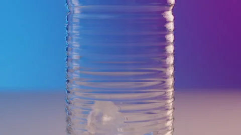 Pano shot bartender pours ice cubes from shaker into a beautiful narrow fluted Video stock 246386930