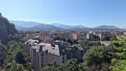 Panorama across Grenoble rooftops to layered alpine ridges beyond the valley, Stock Footage 344531904