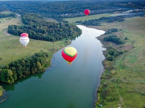 Panorama of balloon flight from altitude in summer above the river. Stock Photos