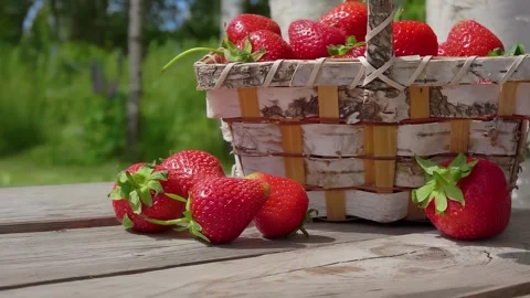 Panorama of basket standing next to the large strawberries on the wooden table Stock Footage 288963002