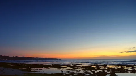 Panorama of a beach after sunset with dark blue and red sky during low tide Video stock 114820131