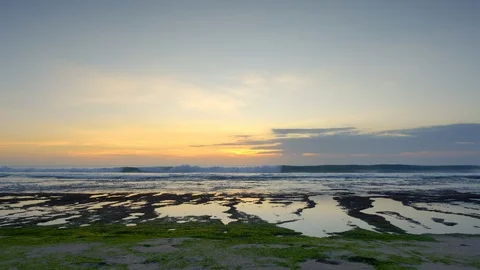 Panorama of beautiful sunset ocean during low tide with high waves on reef Stock Footage 114819829