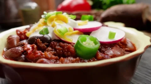 Panorama closeup of chili beef with sour cream and toppings Stock Footage 312468992
