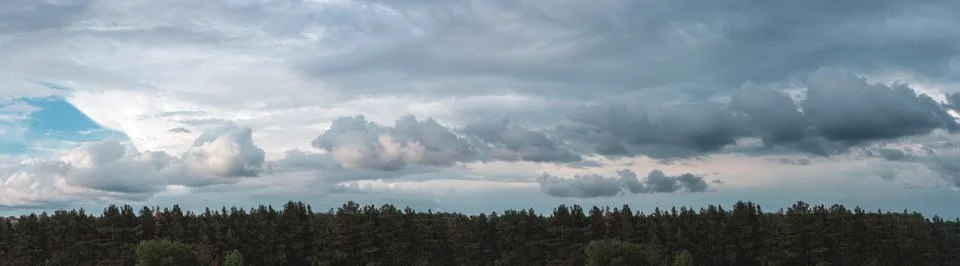 Panorama with clouds over a small forest Stock Photos
