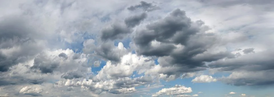 Panorama of clouds of spring storm sky. Dark sky, danger. Weather forecast sc Stock Photos