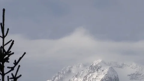 Panorama with clouds waving over snow capped peaks Stock Footage 78220592