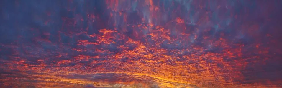 Panorama of cloudscape at sunset with red clouds on sky Stock Photos
