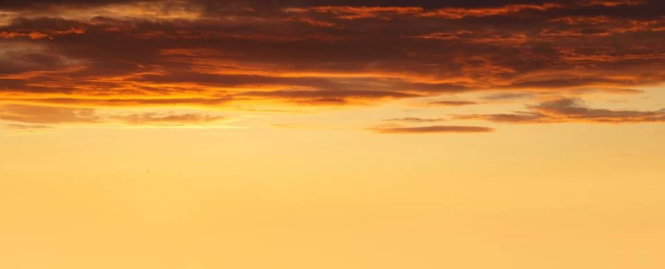 Panorama of cloudscape at sunset with red clouds and copyspace Stock Photos
