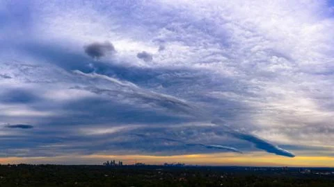 Panorama of dramatic colorful sky, cloud patterns and storm front over Sydney Stock Photos