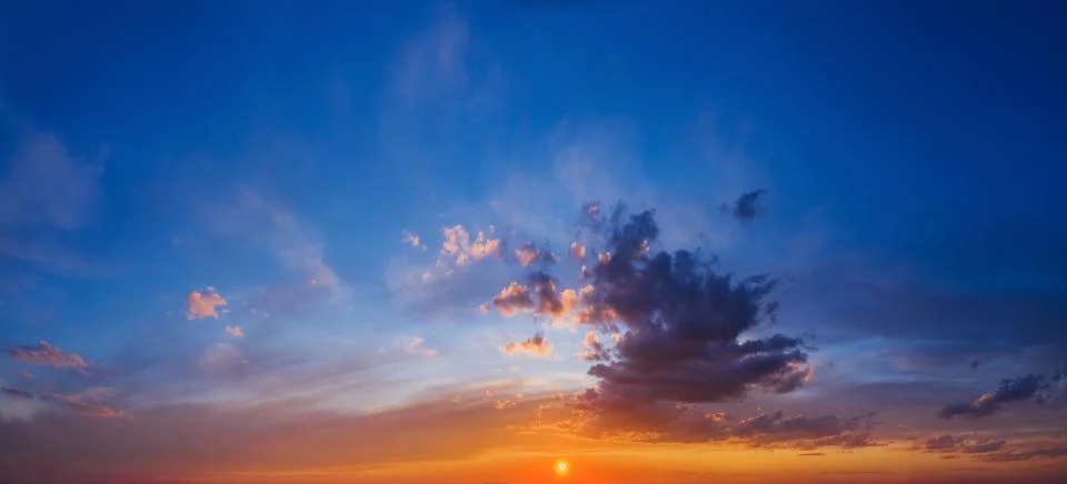 Panorama of dramatic sky with clouds at sunset. Stock Photos