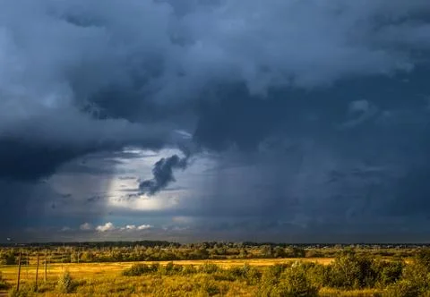 Panorama of dramatic stormy clouds over the village Stock Photos