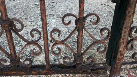 Panorama of a eaten by rust rusty iron gate on the beach Vidéo 81657743