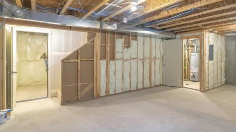 Panorama Empty unfinished large basement with concrete flooring and wooden Stock Photos