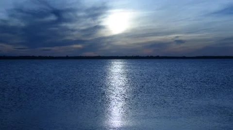 Panorama of enormous sun disk and sun-path across tranquil sea against defocused Stock Footage 67345259