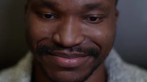 Panorama of the face of a dark-skinned man talking with an online interlocutor Stock Footage 262850833