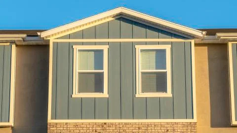 Panorama frame Close up view of sunlit townhouse exterior with clear blue sky Stock Photos