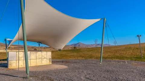 Panorama frame Concrete rectangular structure under a white canopy viewed on a Stock Photos
