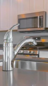 Panorama frame Modern kitchen interior with faucet and sink on the glossy Stock Photos