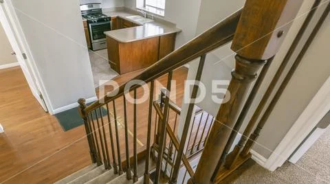 Panorama frame Staircase inside a house overlooking the kitchen and an empty Stock Photos
