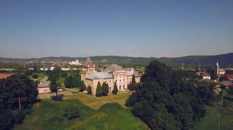 Panorama of green fields with a medieval castle and small town in the background Stock Footage 67317437