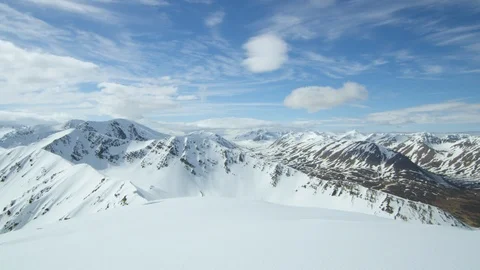 Panorama of High Snowy mountains with cloudy blue sky located in Iceland Stock Footage 124229636