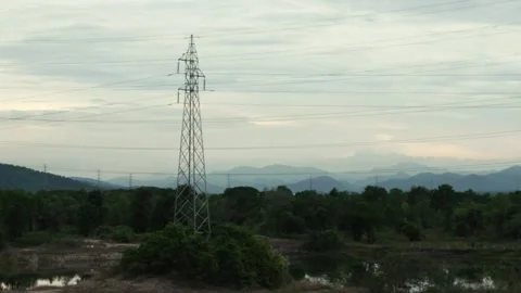Panorama of high voltage power line tower and electric cables stretching across 스톡 동영상 312977288