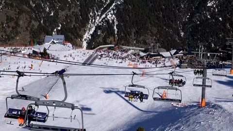 Panorama horizontal. Many people start skiing on a well-groomed ski slope at a Stock Footage 109528230