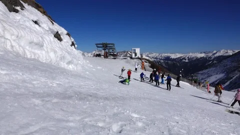 Panorama horizontal. Many people start skiing on a well-groomed ski slope at a Stock Footage 109528582