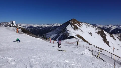 Panorama horizontal. Many people start skiing on a well-groomed ski slope at a Stock Footage 109528590