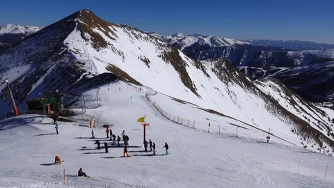 Panorama horizontal. Many people start skiing on a well-groomed ski slope at a Stock Footage 109528677