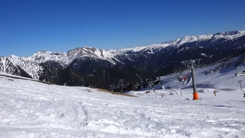 Panorama horizontal. Many people start skiing on a well-groomed ski slope at a Stock Footage 109529103