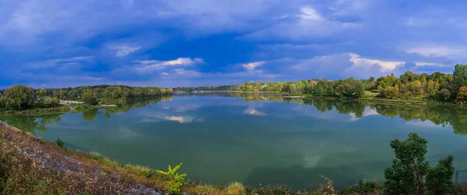 Panorama of lake with clouds Stock Photos