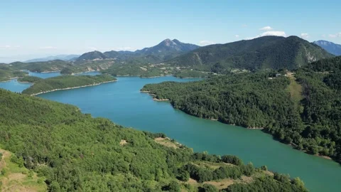 Panorama of Lake Plastiras surrounded by dense green pine forest and mountains Stock Footage 340512860