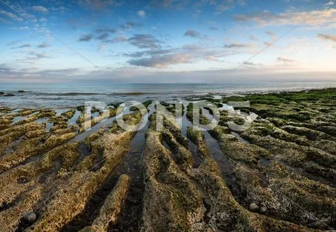 Panorama landscape looking out to sea with rocky coastline and beautful vibra Stock Photos
