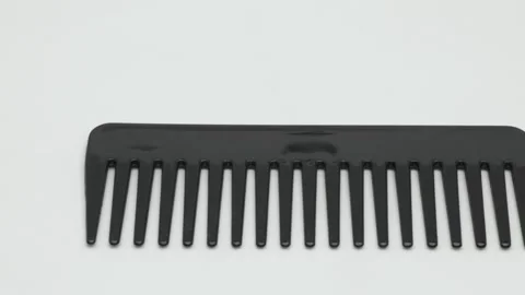 Panorama of a large black plastic comb on a white background. 動画素材 270055942