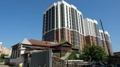 Panorama from modern multi-storey building to old wooden house Stock Footage 294625315