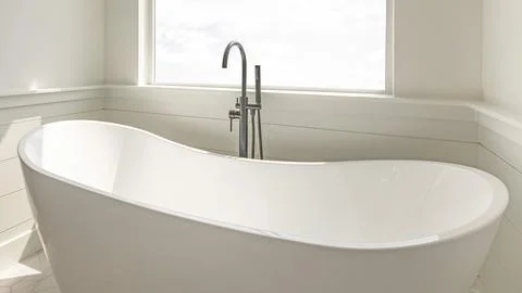 Panorama Modern solid base freestanding tub with floor mount dual faucets a.. Stock Photos