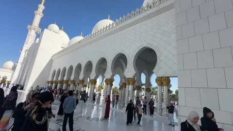 Panorama motion shot of iconic white Sheikh Zayed Grand Mosque courtyard with Stock Footage 327322904