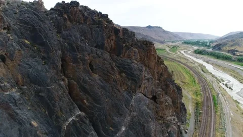 Panorama of the mountain landscape. a train is passing by. river flows. Stock Footage 161071461