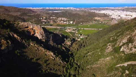 Panorama of the mountain slopes. Seashore in the background Stock Footage 241516898