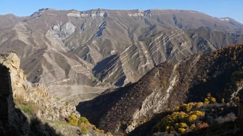 Panorama of mountain slopes with yellowed trees on a clear autumn day Stock Footage 146442441