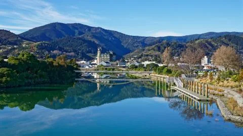 Panorama of Nelson City, reflected in the Maitai River, New Zealand. Stock Photos