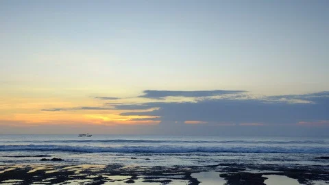 Panorama of ocean after sunset with high waves on reef with small boat Stock Footage 114820248