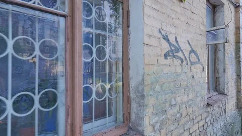 Panorama of Old Walls Windows With Grates Sunny Summer Day Vandalism Words Are Stock Footage 71635962